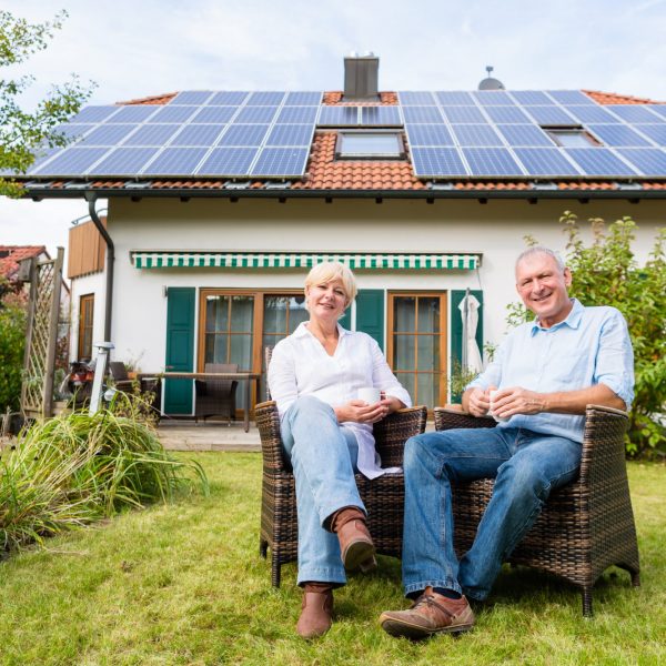 senior-man-woman-sitting-front-house senior-man-woman-sitting-front-house