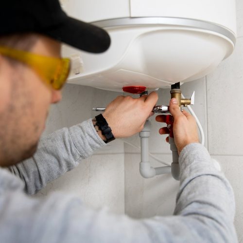 worker-repairing-water-heater